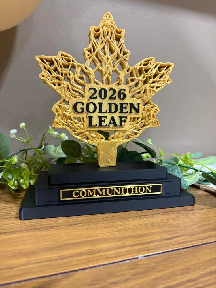a gold maple-leaf trophy reading 2026 Golden Leaf on a stepped black base with a COMMUNITHON plate.